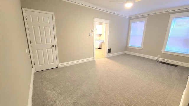 carpeted spare room with ceiling fan