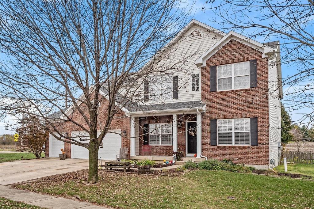 front facade featuring a front yard and a garage