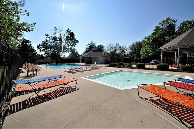 view of swimming pool featuring a patio area