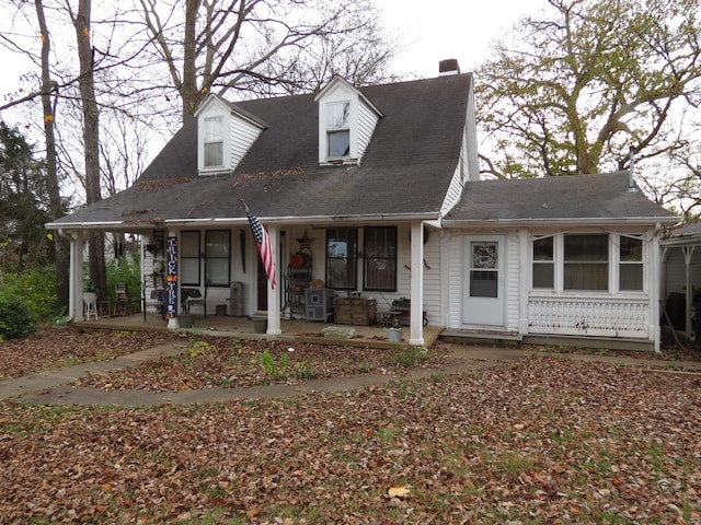 cape cod-style house featuring a porch