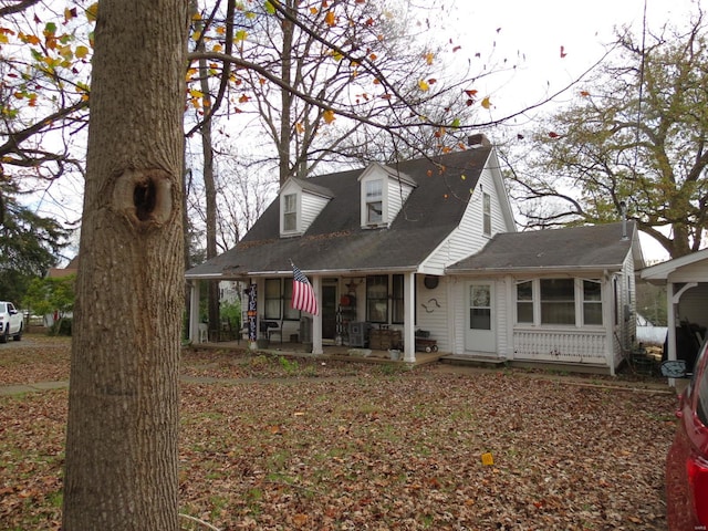 rear view of property featuring a porch