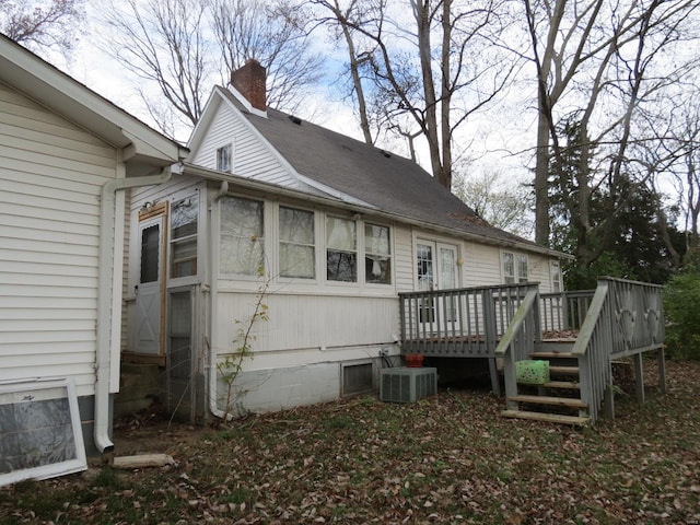 view of property exterior featuring a wooden deck and central AC