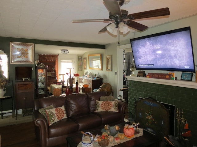 living room featuring hardwood / wood-style floors, a brick fireplace, and ceiling fan