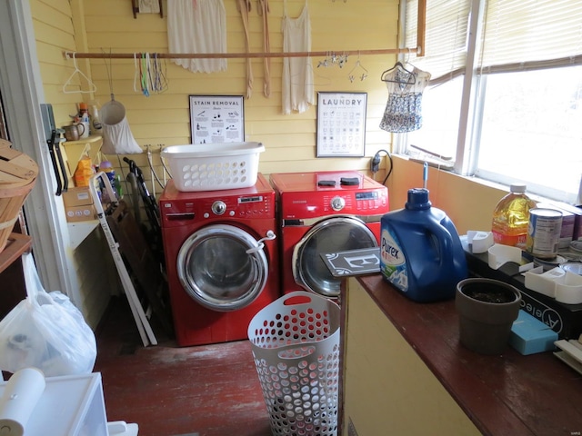 laundry room featuring hardwood / wood-style flooring, wood walls, and independent washer and dryer