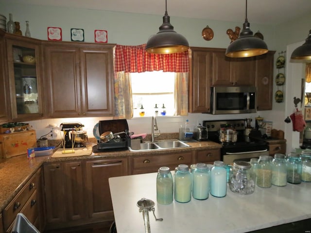 kitchen with hanging light fixtures, sink, and black range with electric cooktop