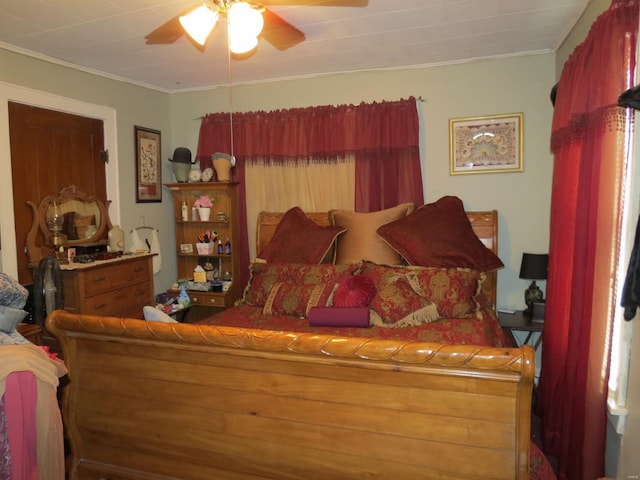 bedroom with ceiling fan and ornamental molding