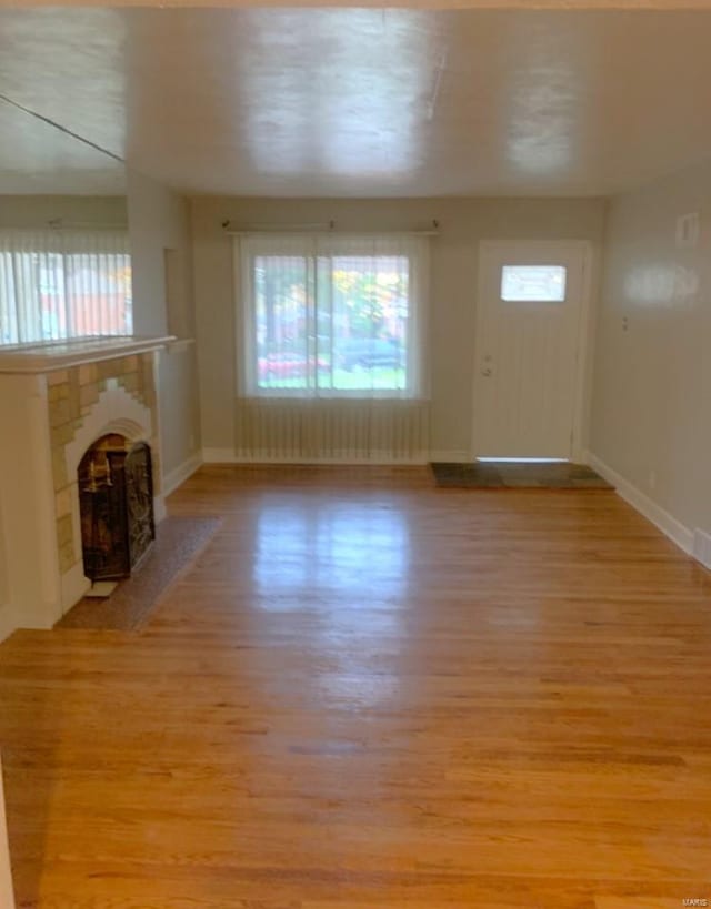 unfurnished living room with light hardwood / wood-style floors