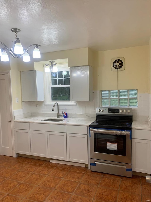 kitchen featuring backsplash, white cabinetry, sink, and stainless steel electric range