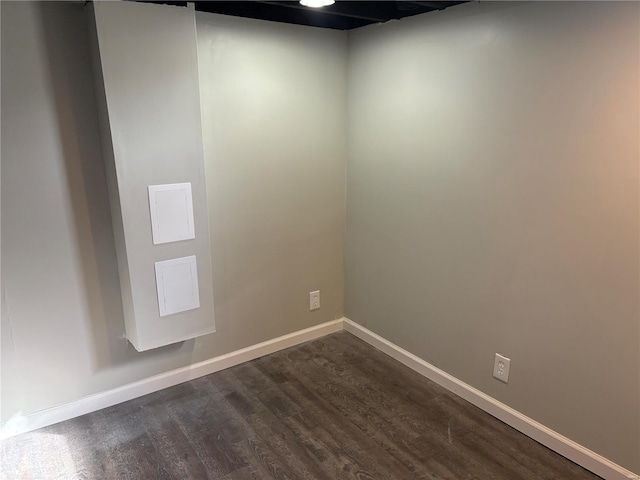 empty room with dark hardwood / wood-style flooring