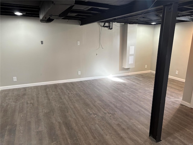 basement with dark hardwood / wood-style floors