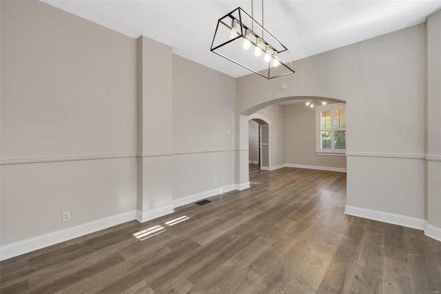 unfurnished dining area featuring dark hardwood / wood-style flooring