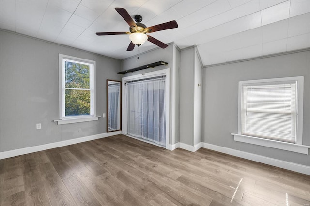 unfurnished bedroom with light hardwood / wood-style flooring, ceiling fan, and crown molding