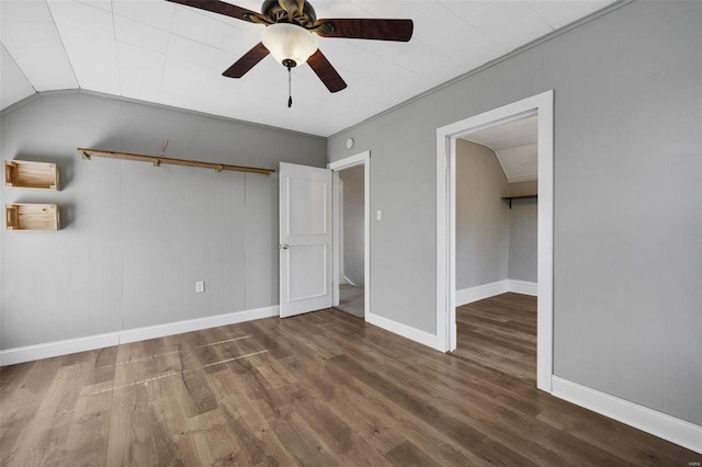 unfurnished bedroom with ornamental molding, ceiling fan, hardwood / wood-style flooring, a closet, and lofted ceiling