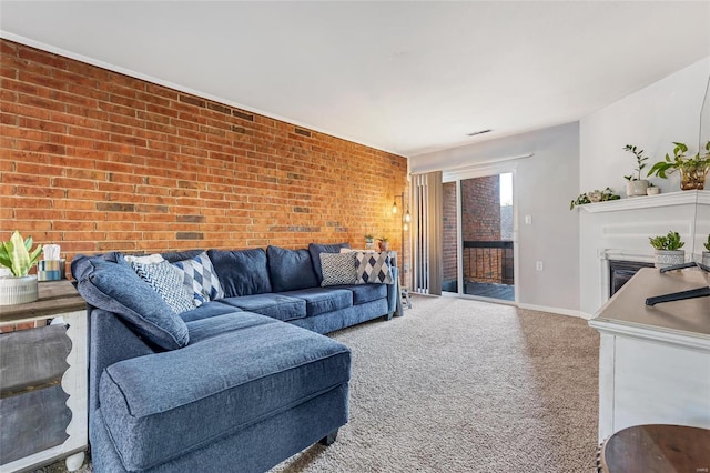 carpeted living room featuring brick wall