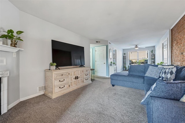 living room with ceiling fan, a fireplace, and carpet