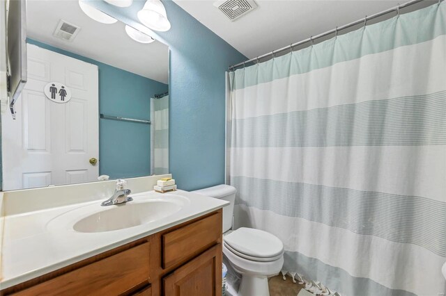 bathroom with vanity, toilet, and walk in shower