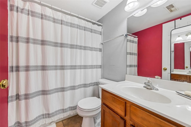 bathroom with tile patterned floors, vanity, and toilet