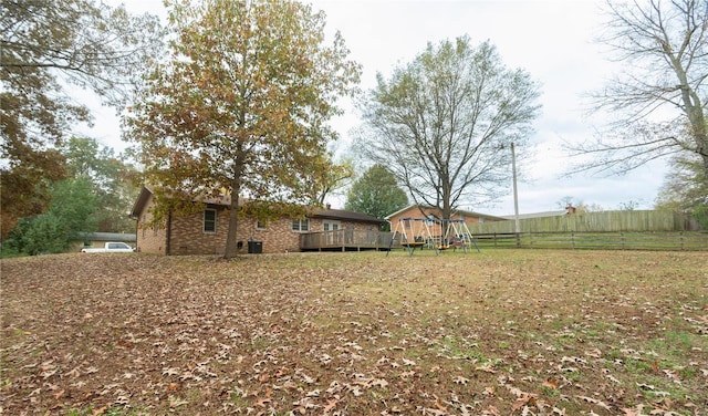 view of yard with a playground and a wooden deck