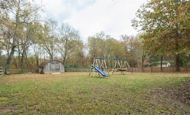 view of yard featuring a storage unit and a playground