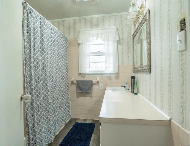 bathroom with vanity, wood-type flooring, and tile walls