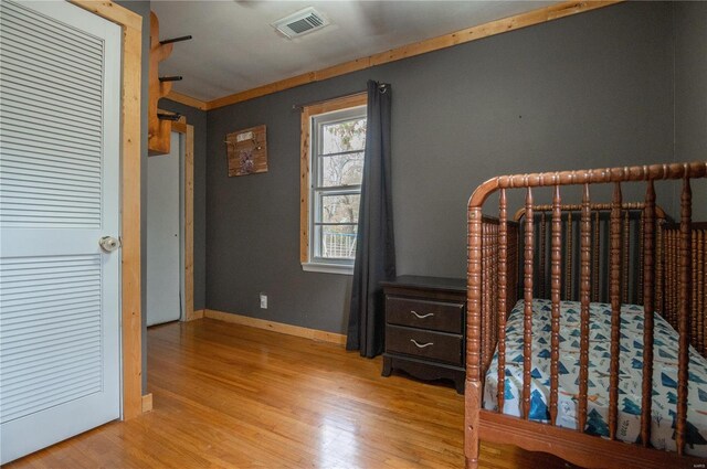 unfurnished bedroom with crown molding and light hardwood / wood-style flooring