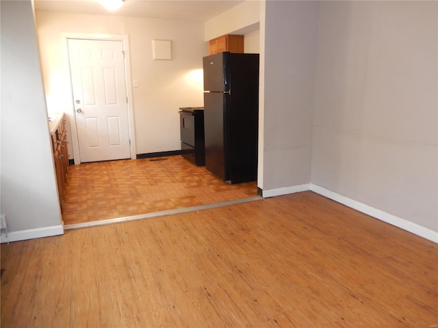 empty room with baseboards and parquet flooring