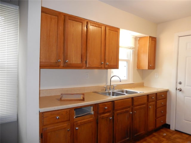 kitchen featuring dark parquet flooring and sink