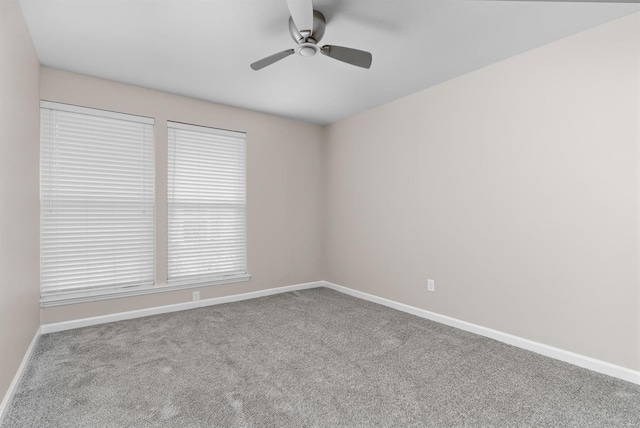 carpeted spare room featuring ceiling fan