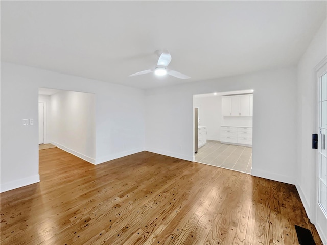 spare room with light hardwood / wood-style floors and ceiling fan