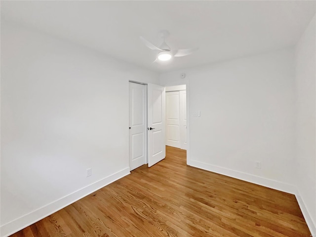 spare room featuring light hardwood / wood-style flooring and ceiling fan