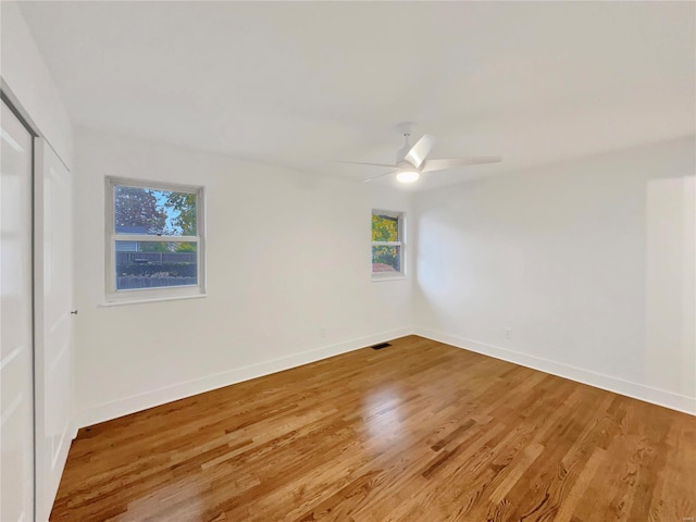 unfurnished room with hardwood / wood-style floors and ceiling fan