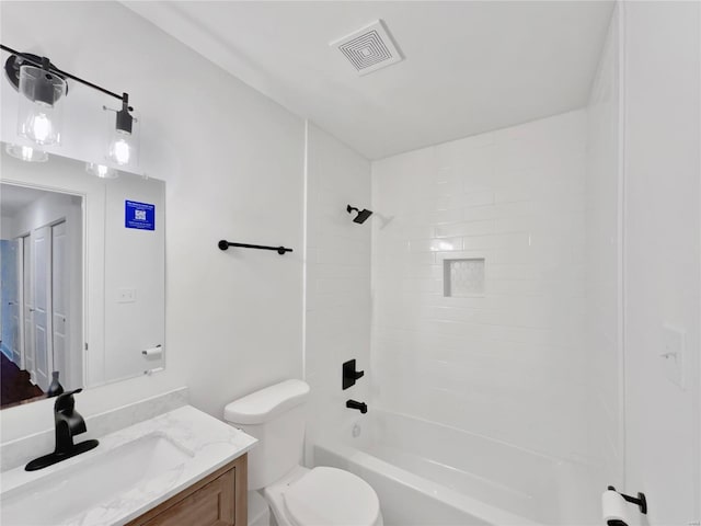 full bathroom featuring vanity, toilet, and tiled shower / bath