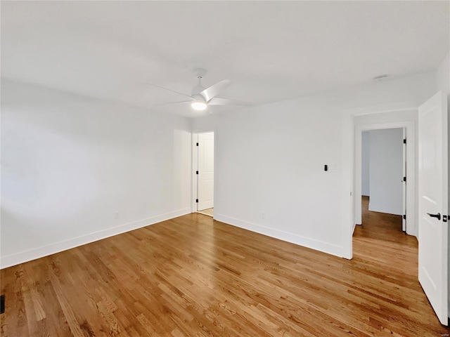 empty room featuring hardwood / wood-style floors and ceiling fan