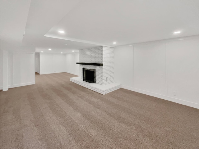 unfurnished living room featuring carpet floors and a fireplace