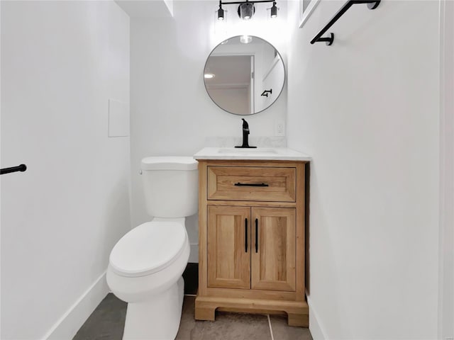 bathroom with tile patterned flooring, vanity, and toilet