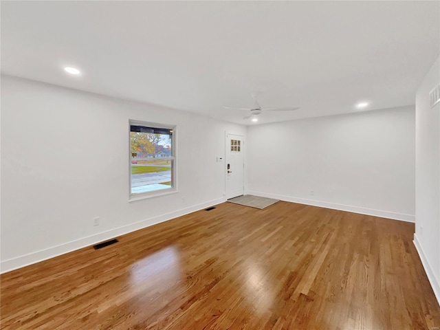 unfurnished room with hardwood / wood-style flooring and ceiling fan