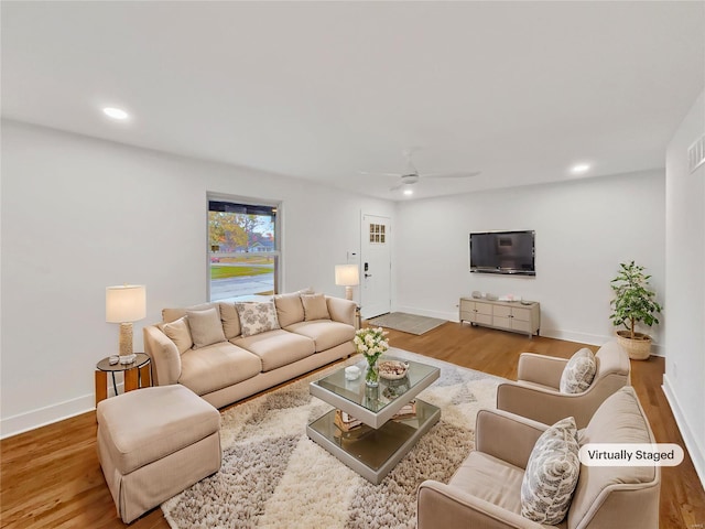 living room with hardwood / wood-style floors and ceiling fan