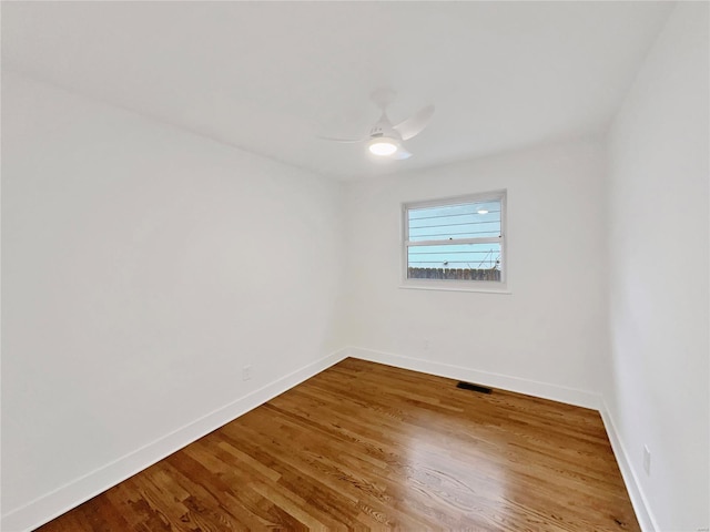 unfurnished room with hardwood / wood-style flooring and ceiling fan