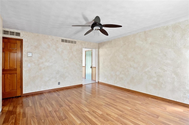 unfurnished room with ceiling fan and hardwood / wood-style flooring