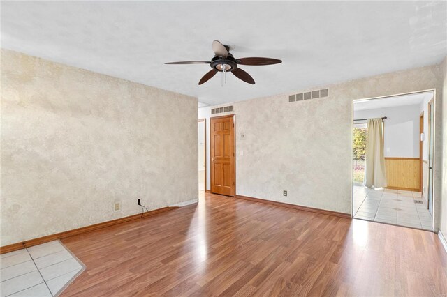 unfurnished room with ceiling fan and light hardwood / wood-style floors