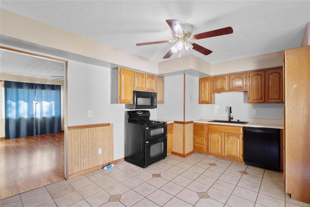 kitchen featuring black appliances, sink, ceiling fan, light tile patterned floors, and a textured ceiling