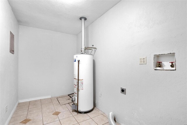 washroom featuring gas water heater, washer hookup, light tile patterned floors, a textured ceiling, and hookup for an electric dryer