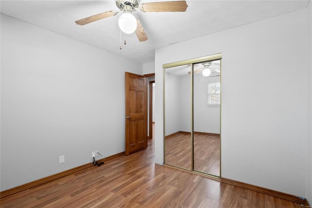 unfurnished bedroom with ceiling fan, light hardwood / wood-style floors, and a closet