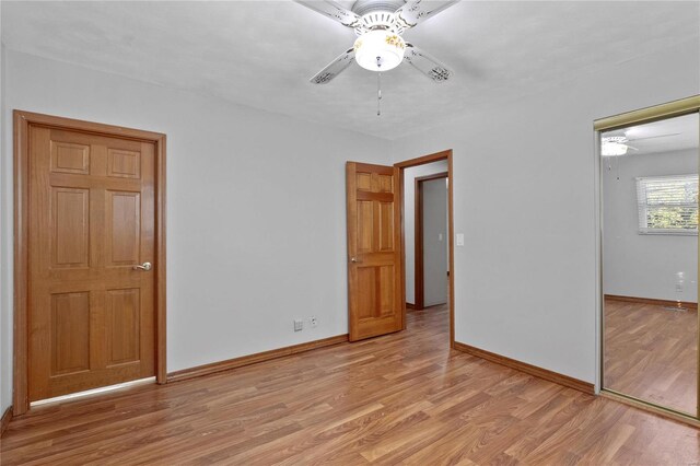 unfurnished bedroom featuring a closet, light hardwood / wood-style floors, and ceiling fan