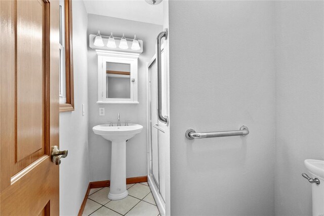 bathroom featuring tile patterned flooring and a shower with door