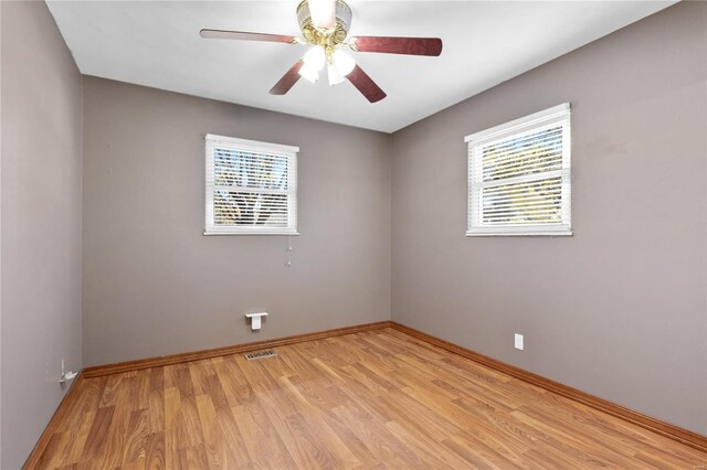 unfurnished room with light hardwood / wood-style floors, plenty of natural light, and ceiling fan