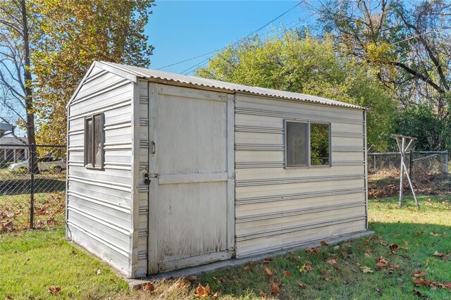 view of outbuilding featuring a lawn