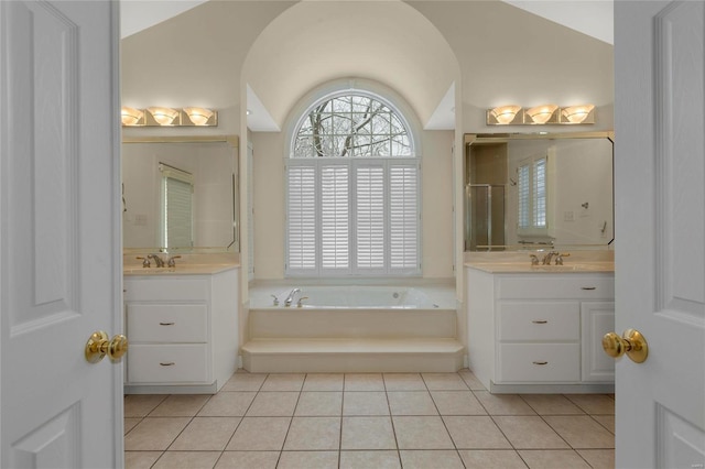 bathroom featuring tile patterned flooring, plus walk in shower, vaulted ceiling, and vanity