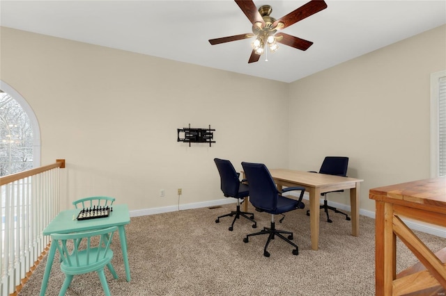 carpeted office featuring ceiling fan