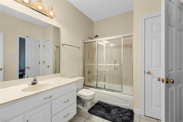 full bathroom featuring vanity, toilet, shower / bath combination with glass door, and tile patterned flooring